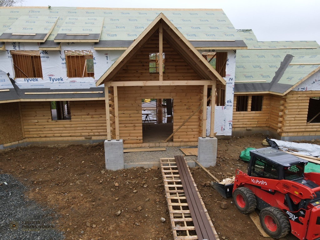 Close aerial view of log cabin entrance and framing detail