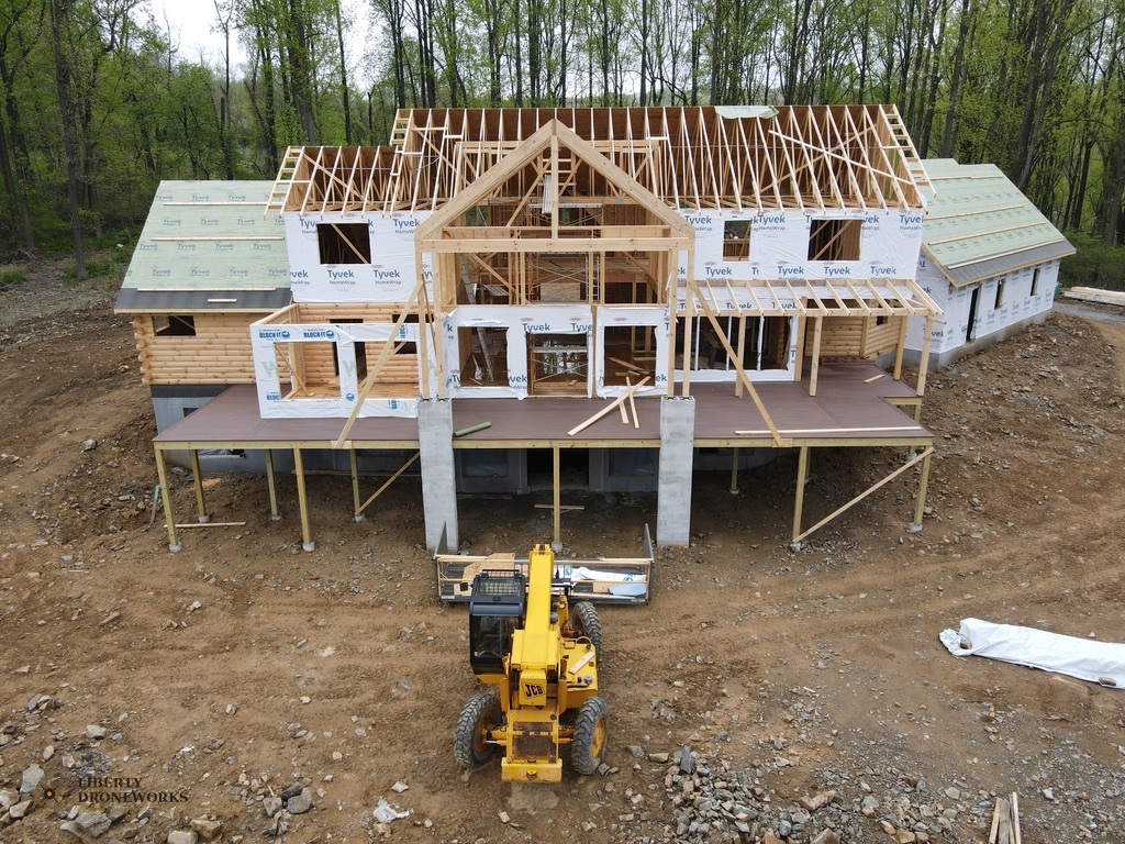 Aerial overview of log cabin construction site with equipment in Mt. Penn Pennsylvania